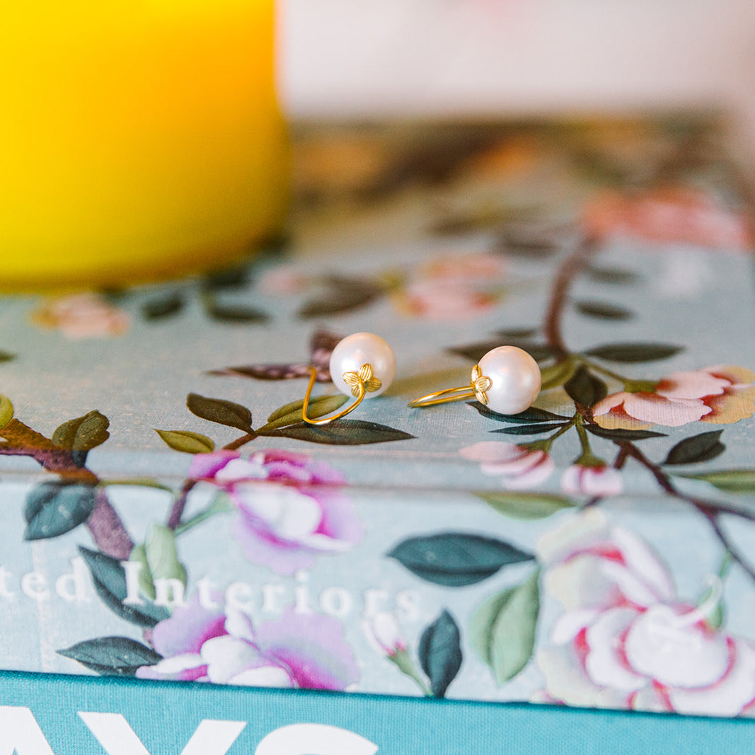 Bloom Pearl Hook earrings displayed on floral print book_m donohue collection
