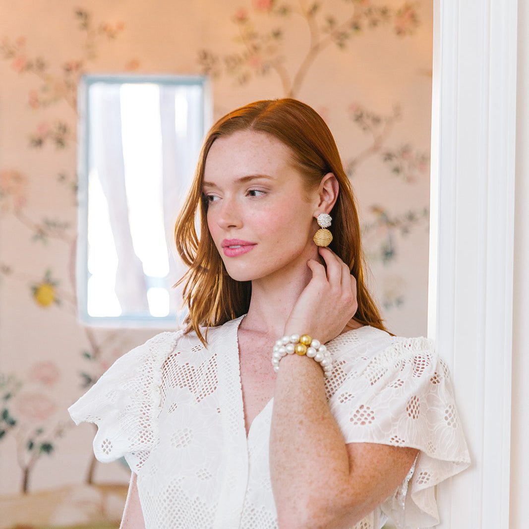 Model is wearing Liz White Rattan Ball Earrings_m donohue collection