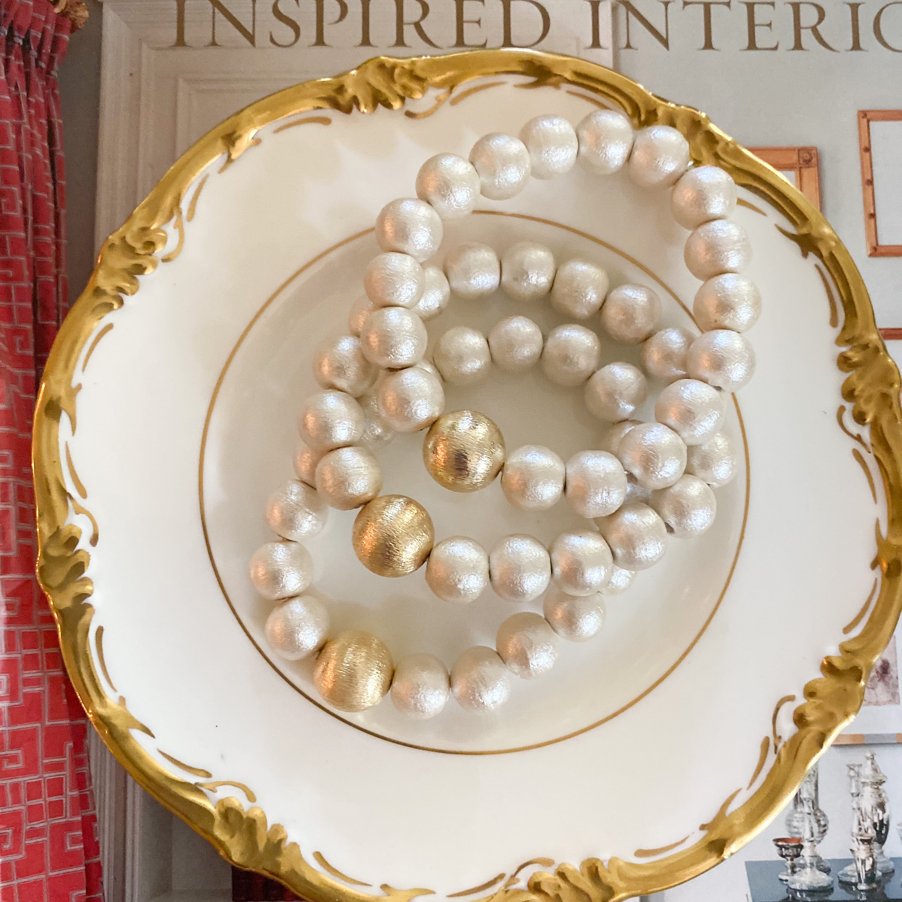 Olivia Cotton Pearl & Gold Bracelet displayed on gold accented china dish_m donohue collection