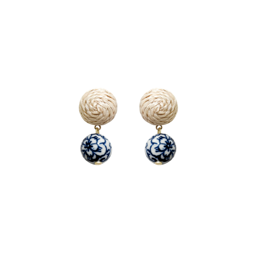 Pair of earrings with woven rattan post top and blue and white porcelain floral bead drop_ m donohue collection