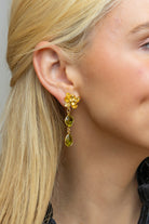 Model wearing Magnolia Flower Moss Peridot Drop Earrings_M Donohue Collection