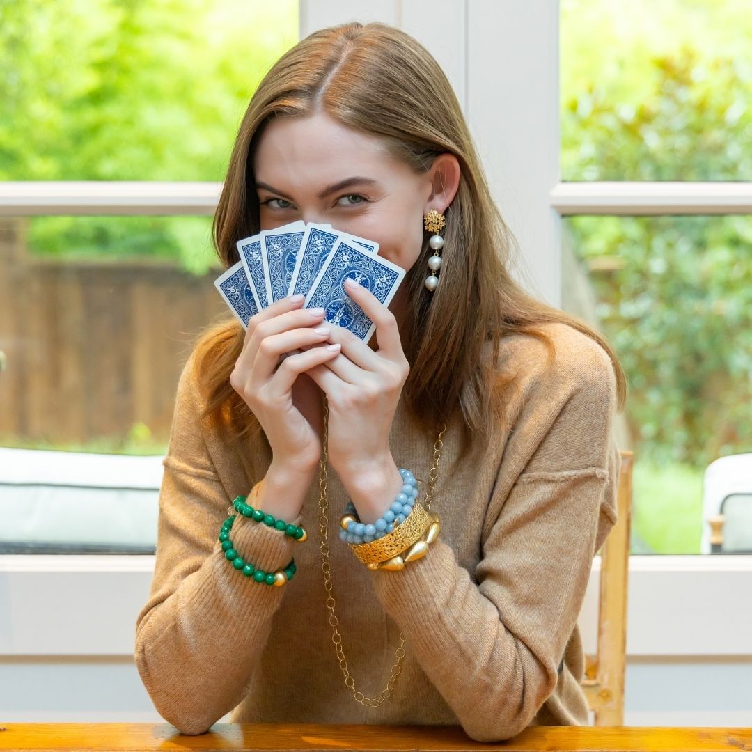 model wearing Jardin gold hydrangea post earrings with bracelets_m donohue collection