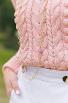Model wears long Annabelle Gold and Lilac gemstone necklace with sweater_m donohue collection