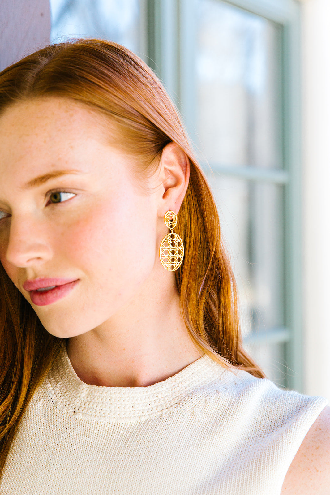 Model is wearing Remy Wicker Gold Oval Link Earrings_m donohue collection