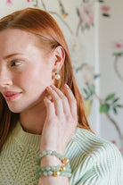 Model is wearing Triomphe Aquamarine and Single Cotton Pearl Earrings_m donohue collection