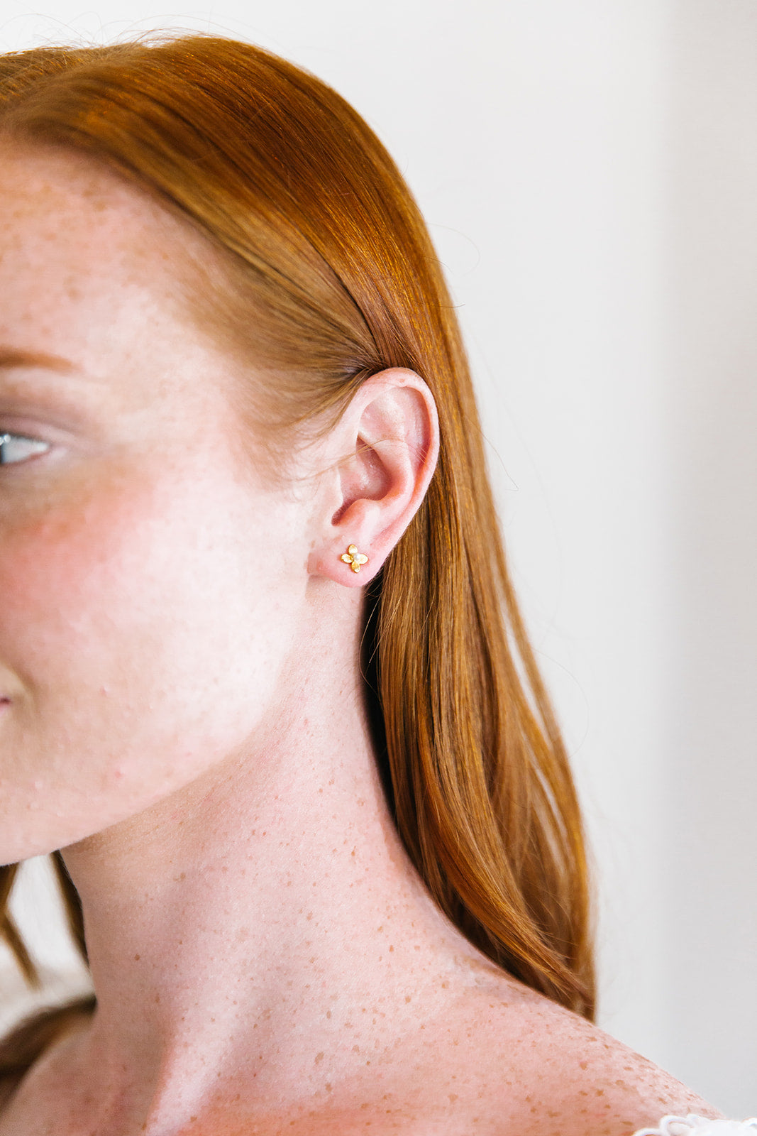 Model is wearing Tiny Bloom Pearl Stud Earrings_m donohue collection