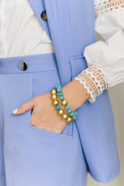 Model is wearing Pamela Gold & Aqua Bracelet_m donohue collection